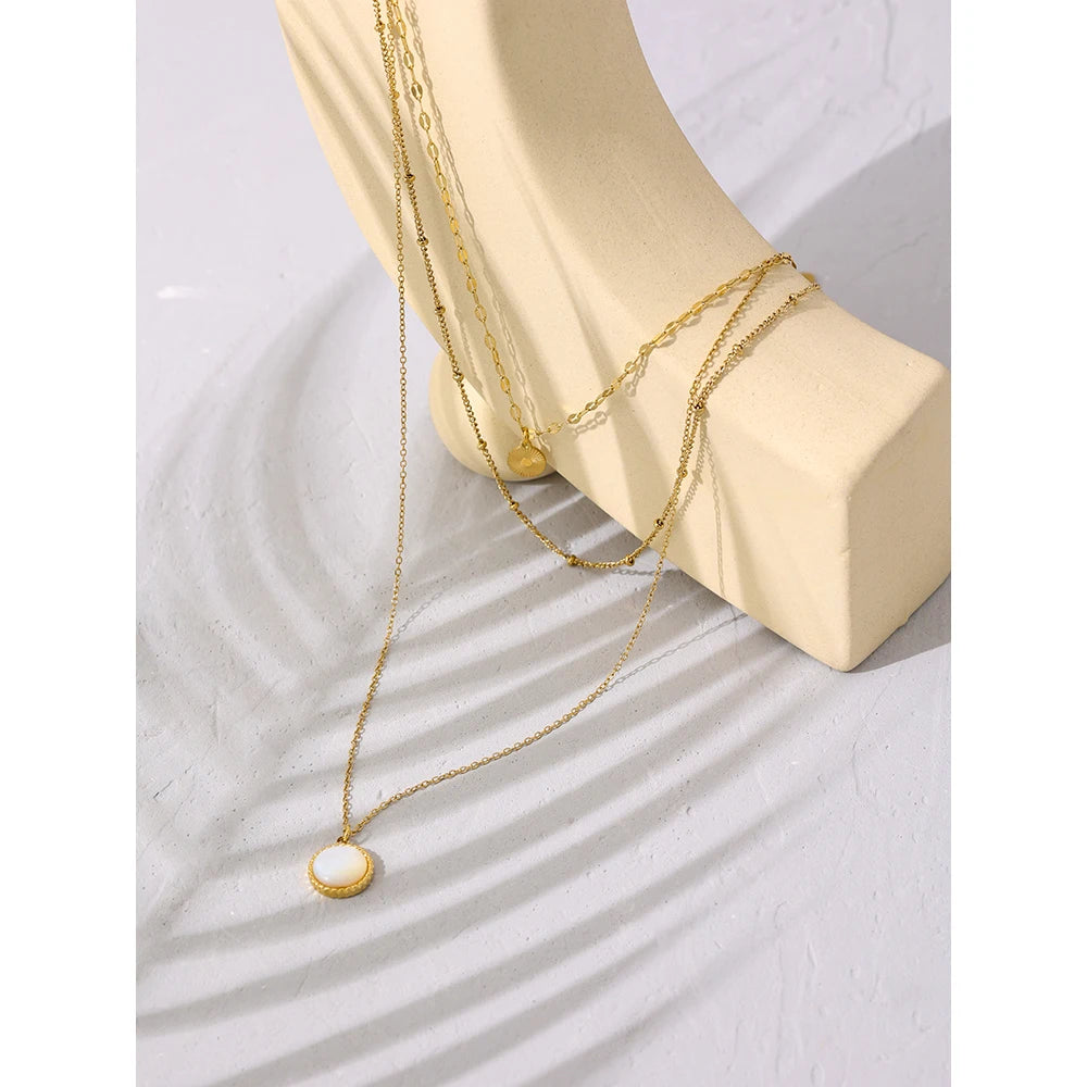 Triple-layer necklace with round pendant, styled shot – Charmhabit