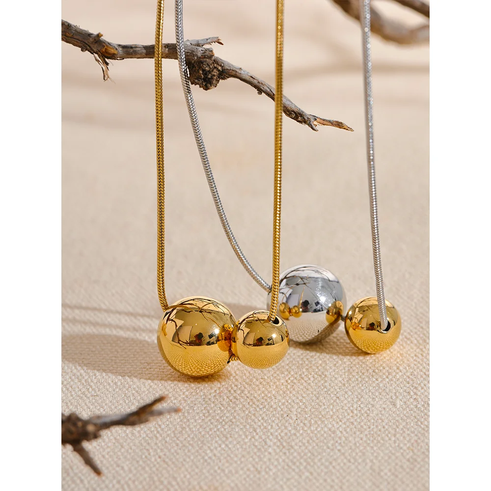 Collier à deux boules, doré et argenté, sur du lin avec une branche – Charmhabit