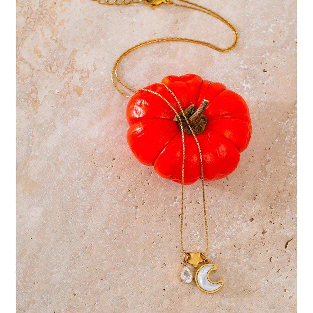 Necklace with shell, moon and star pendant, styled shot – Charmhabit