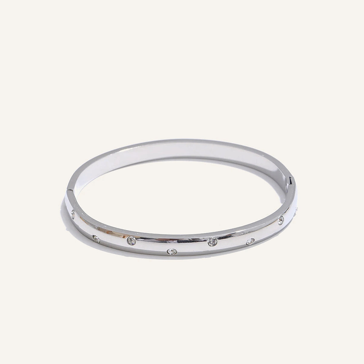 Bangle bracelet with zirconia, silver tone, on a light background – Charmhabit