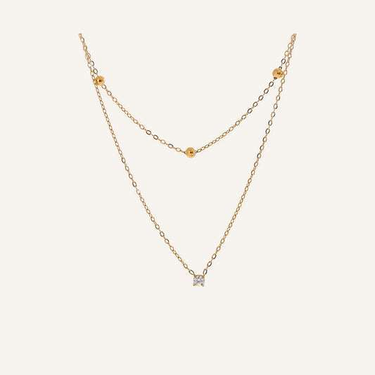 Double necklace with cubic zirconia, gold tone, on a light background – Charmhabit