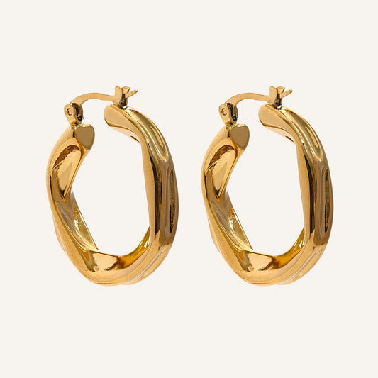 Twisted hoop earrings, gold tone, on a light background – Charmhabit