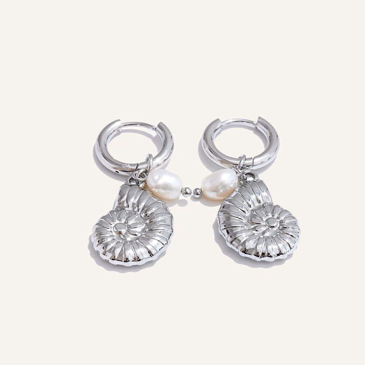 Huggie hoops with sea charm and pearl, snail shell, silver tone, on a light background – Charmhabit