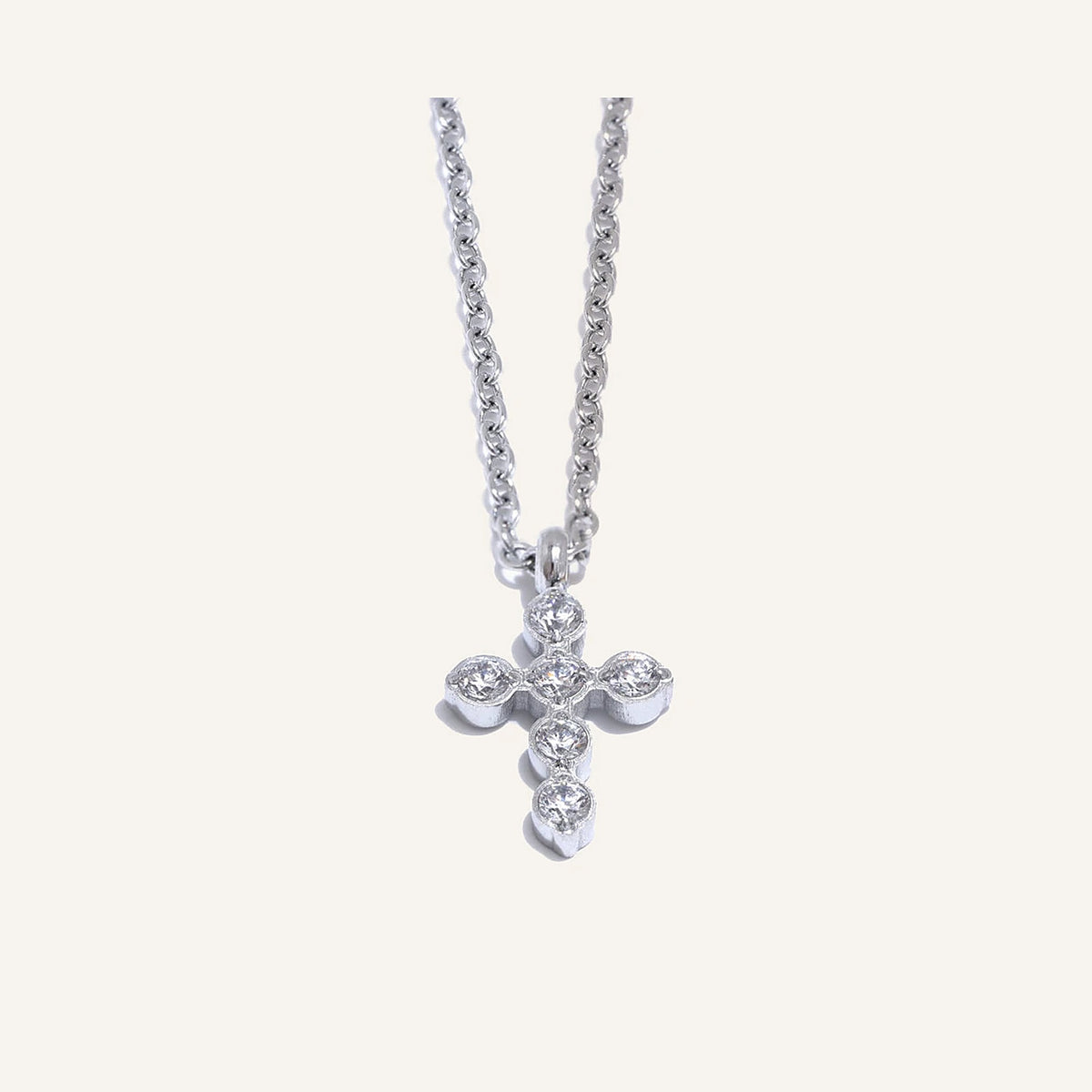 Necklace with cross and zirconia, silver tone, on a light background – Charmhabit