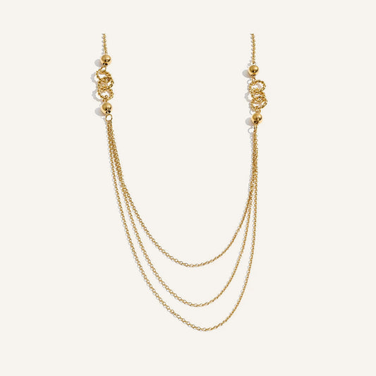 Long layered necklace, gold tone, on a light background – Charmhabit