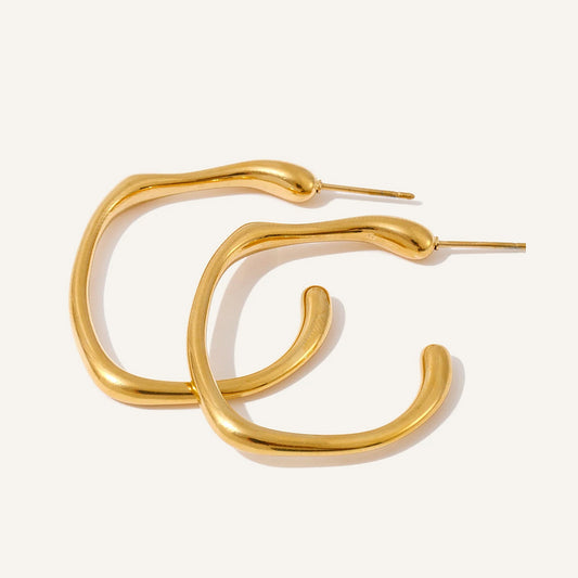 Open C-shaped earrings with a soft curve, gold tone, on a light background – Charmhabit