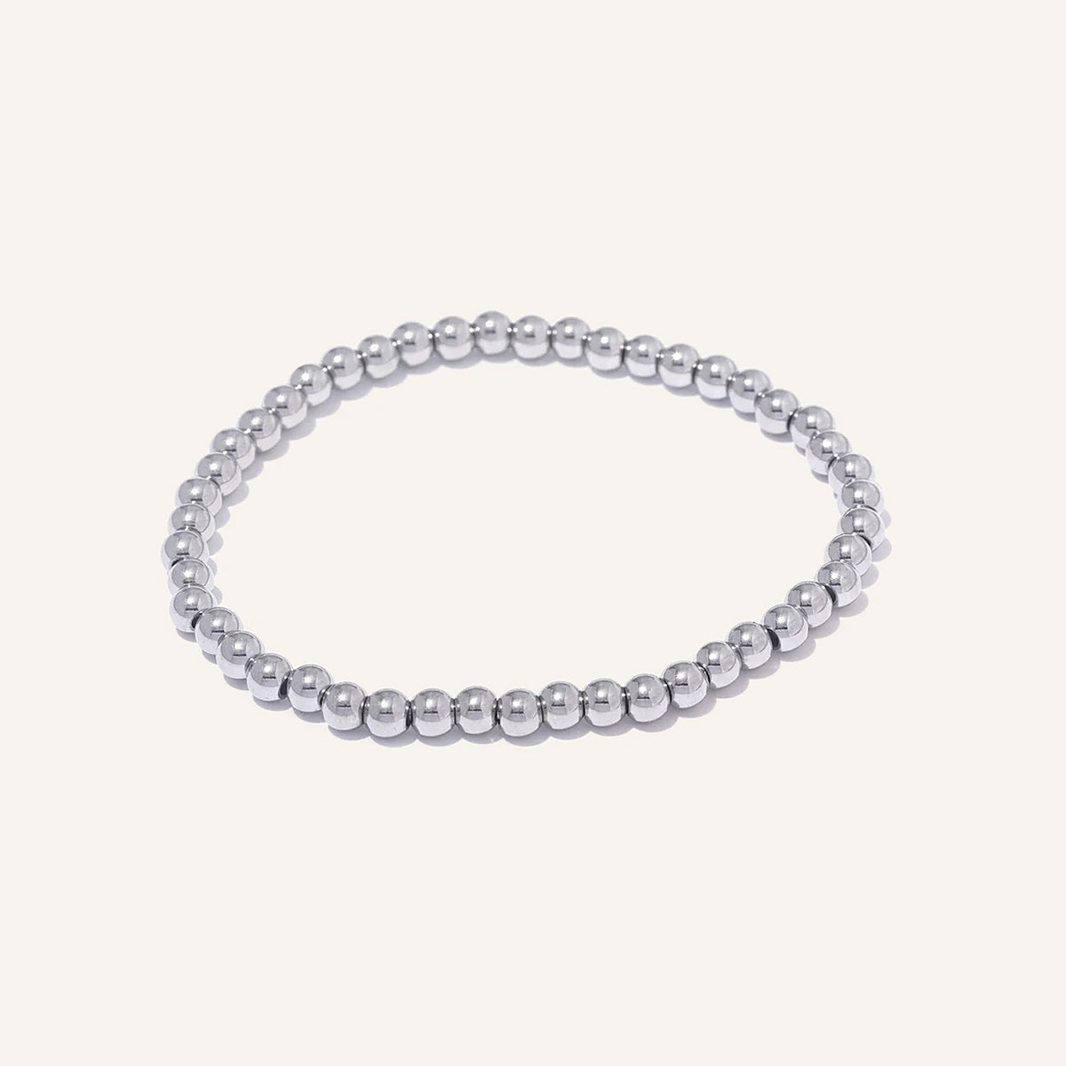 Bracelet élastique avec boules en acier, argenté 4 mm, sur fond clair – Charmhabit