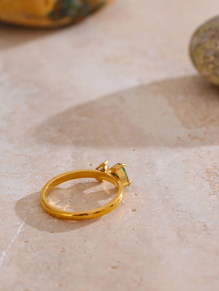 Ring mit grünem und weißem Zirkonia, Seitenansicht auf einem Stein – Charmhabit