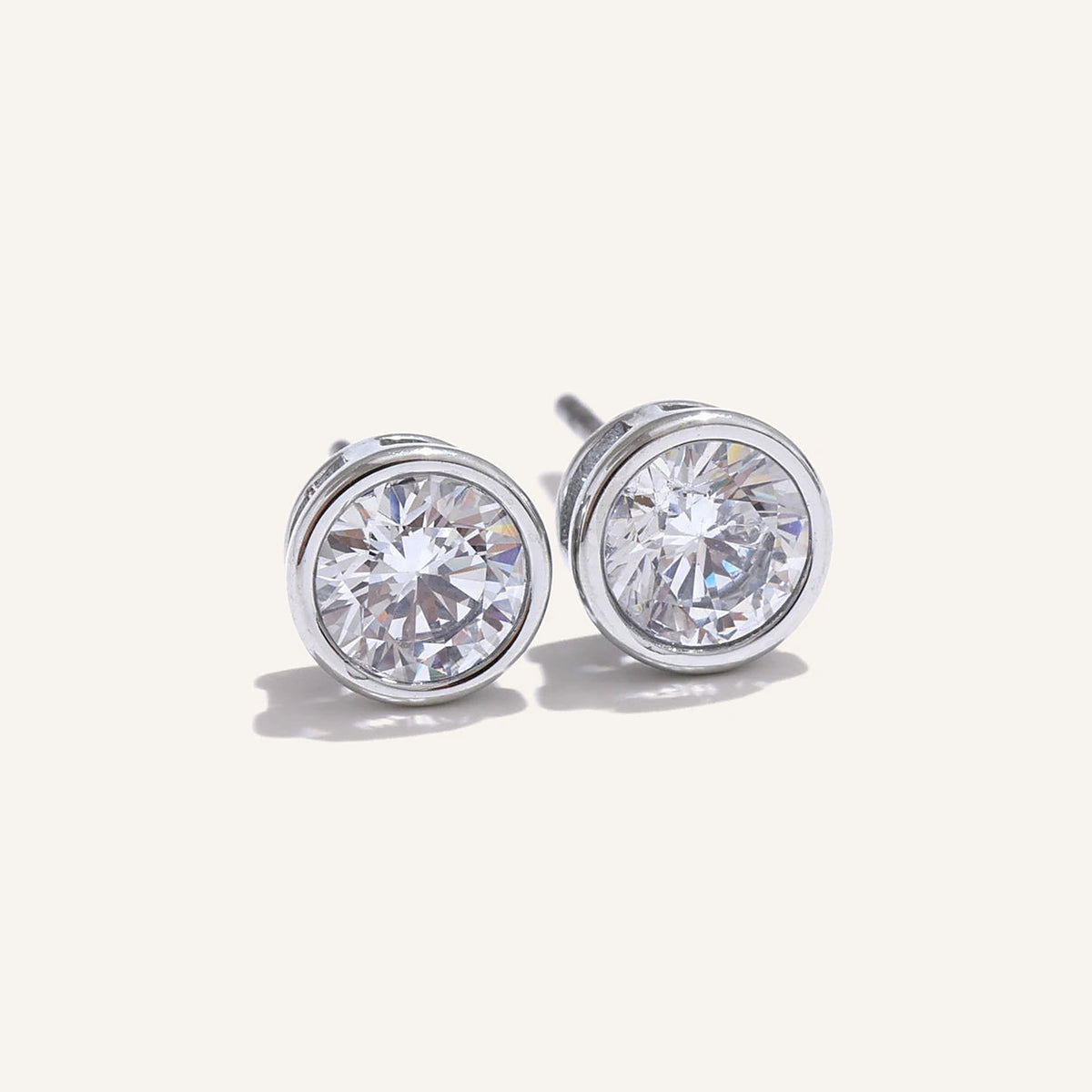 Round cubic zirconia stud earrings, silver tone, on a light background – Charmhabit