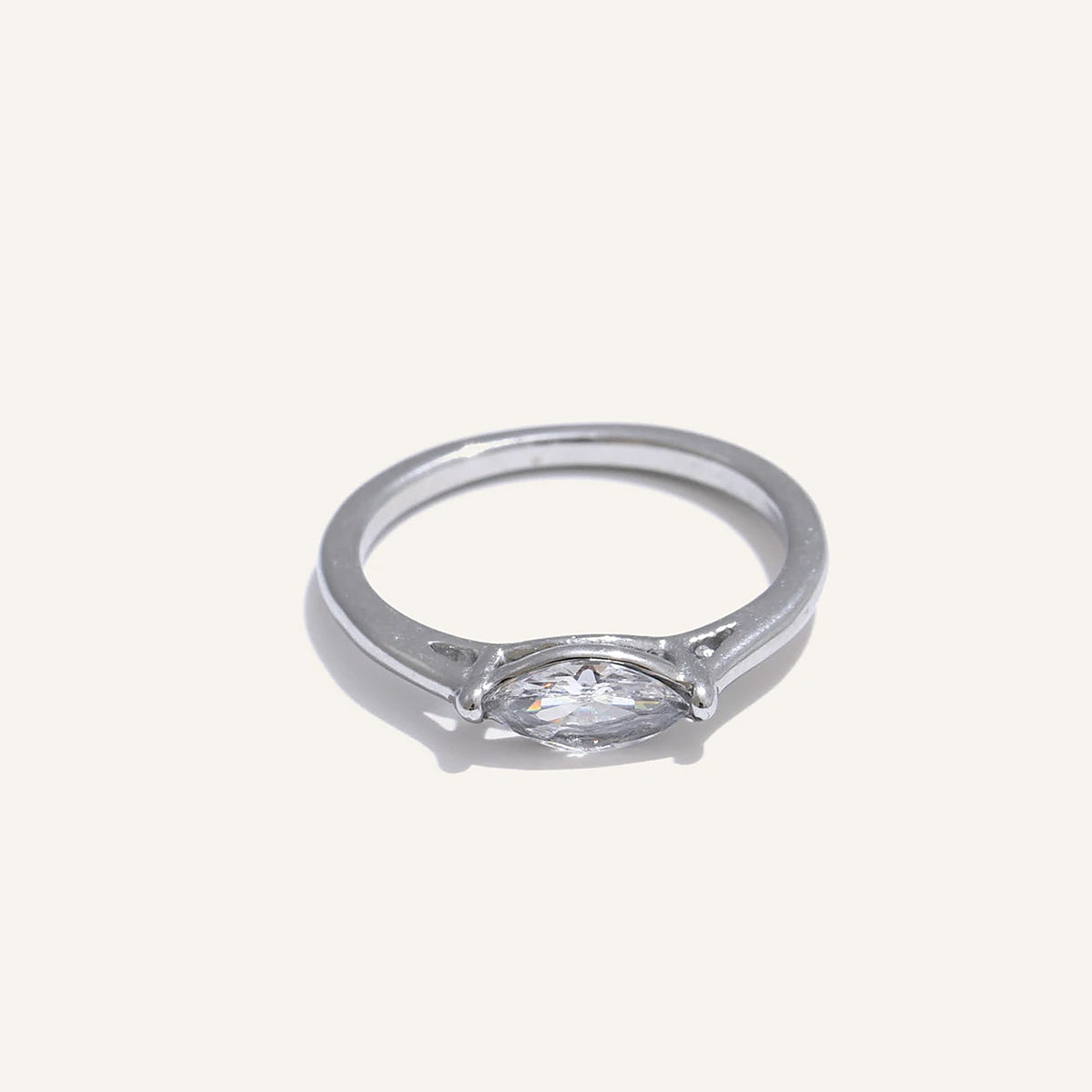Marquise-cut cubic zirconia solitaire ring, silver tone, on a light background – Charmhabit