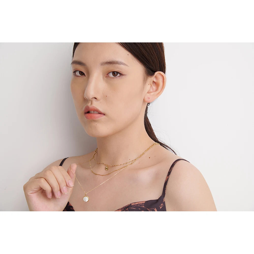 Triple-layer necklace with round pendant, worn – Charmhabit