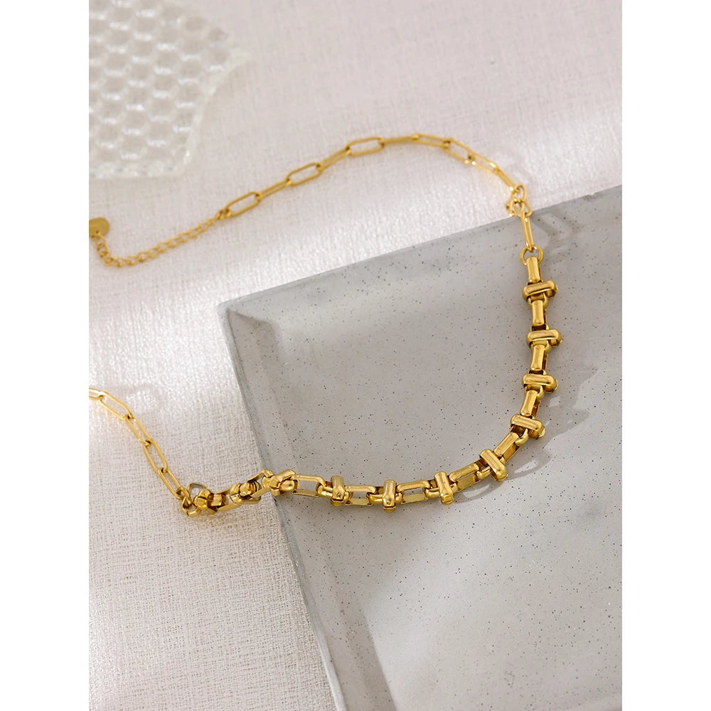 Short choker with gold-tone links in a styled shot – Charmhabit
