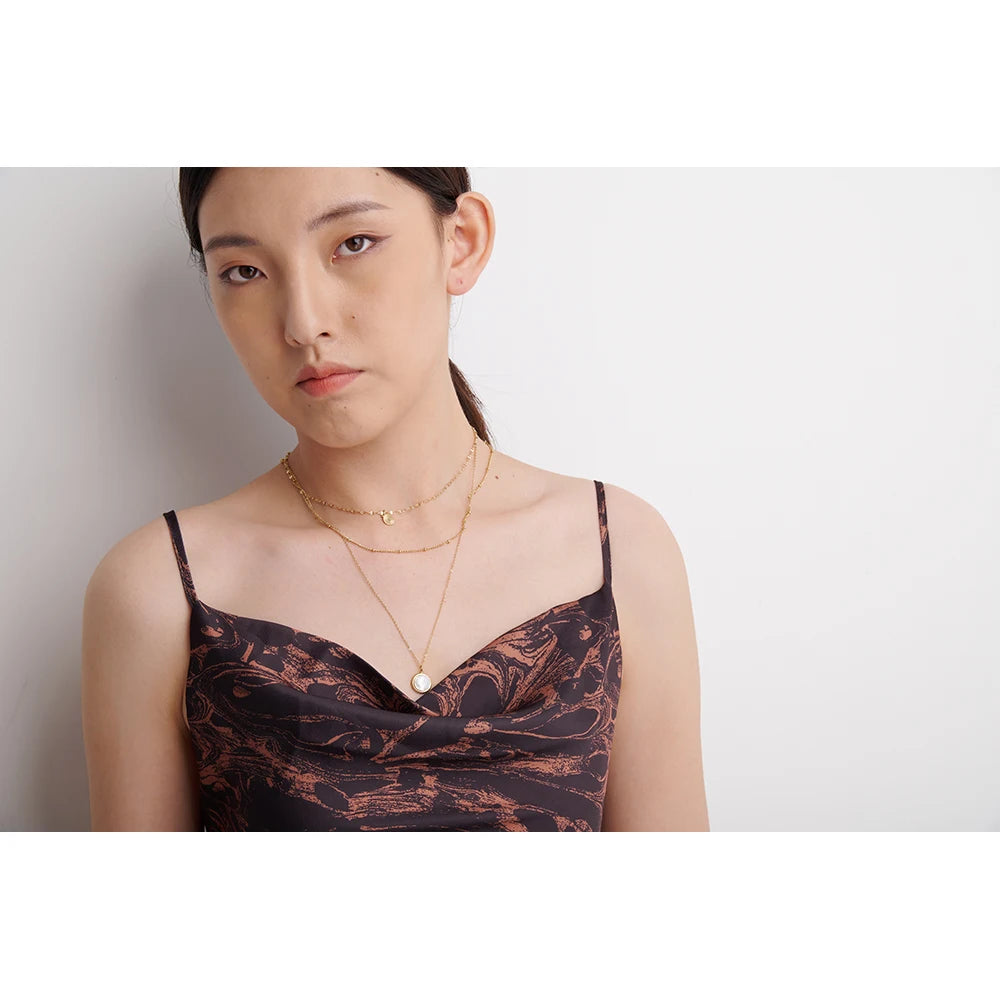 Triple-layer necklace with round pendant, worn – Charmhabit