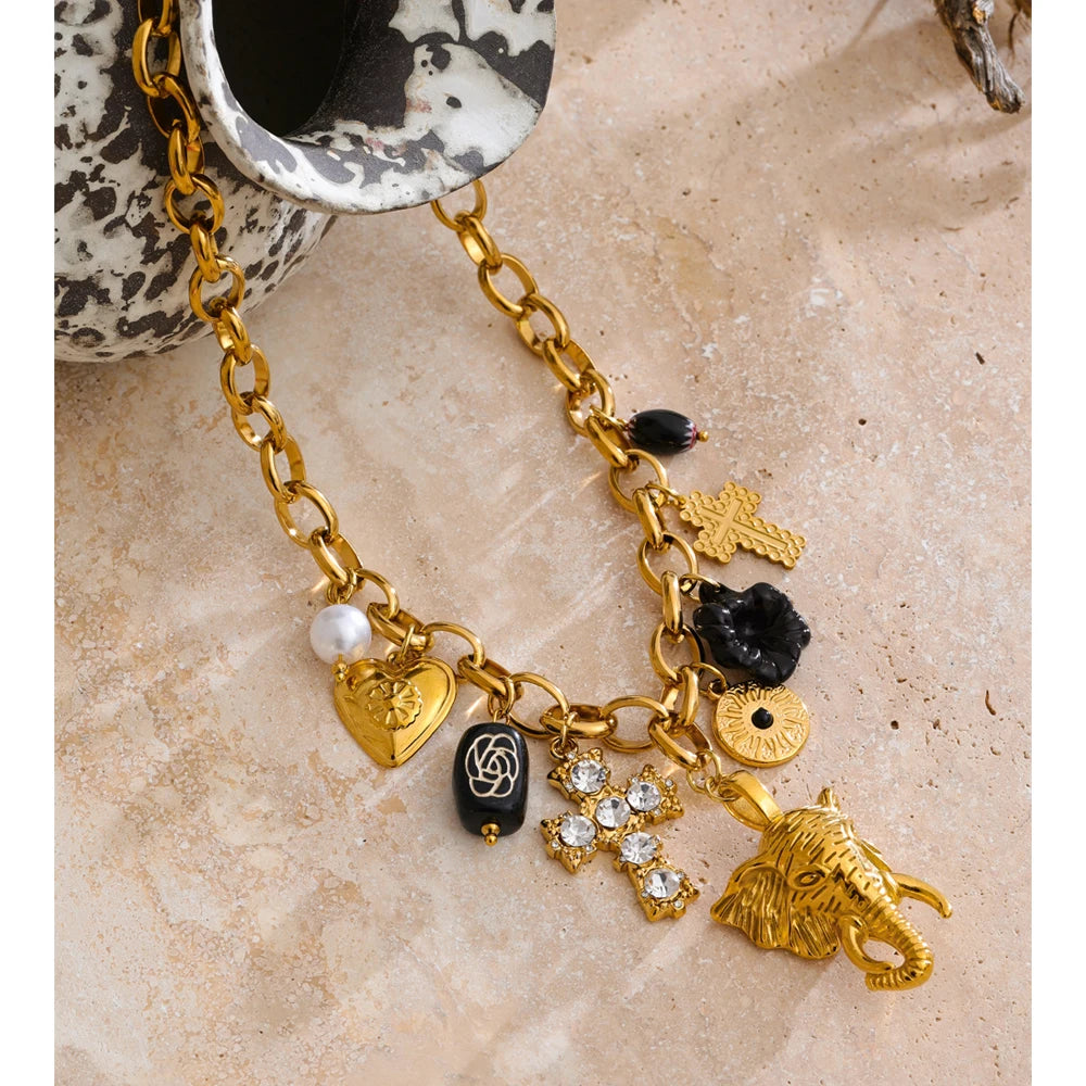 Charm necklace with heart, flower and cross, styled shot – Charmhabit