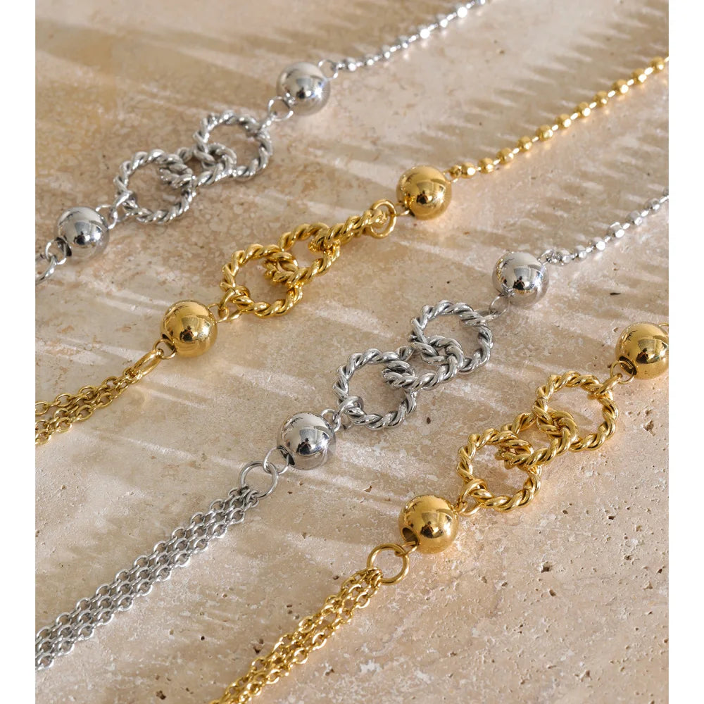 Long layered necklace, gold and silver tone, close-up on stone – Charmhabit