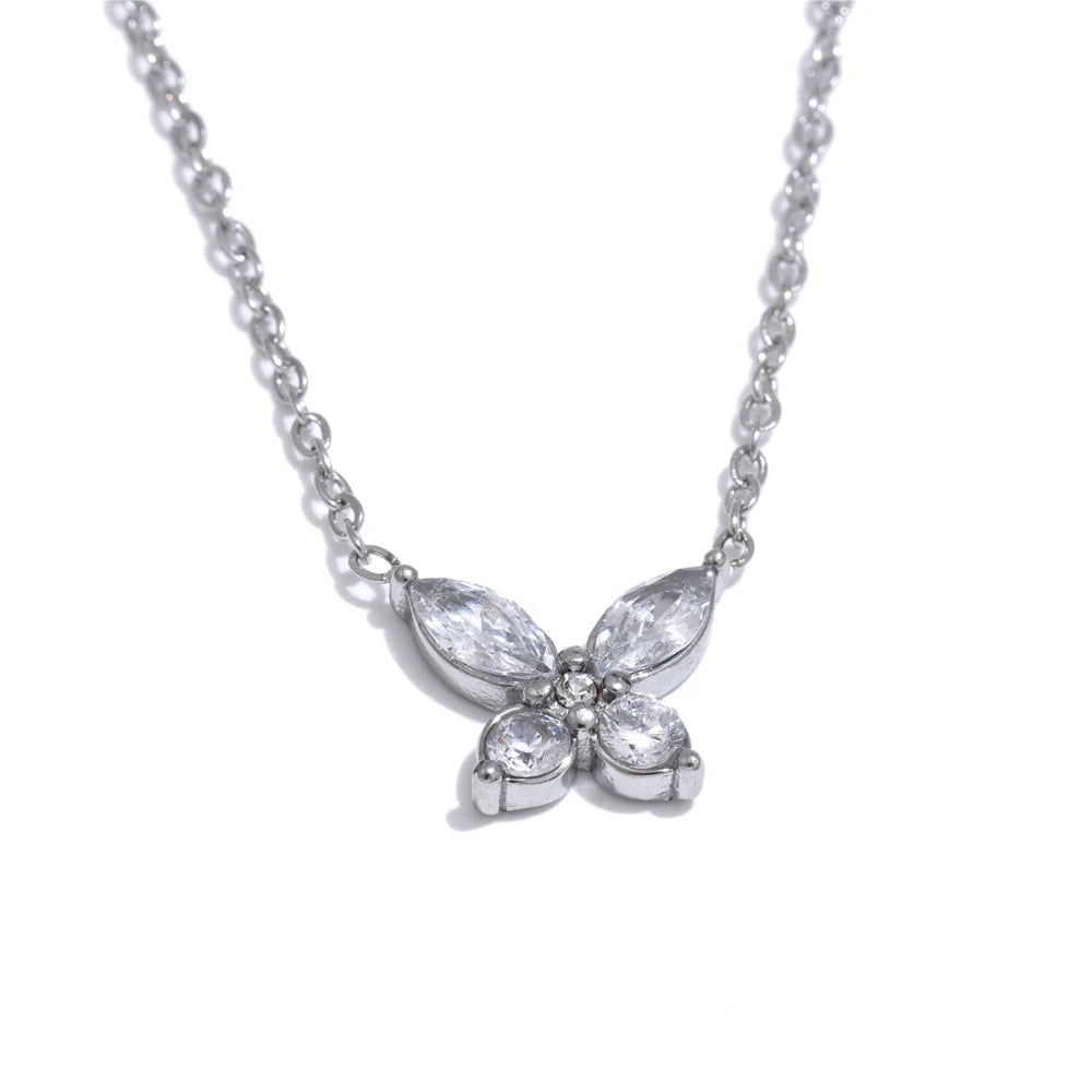 Butterfly necklace with cubic zirconia in a silver tone, on a light background – Charmhabit