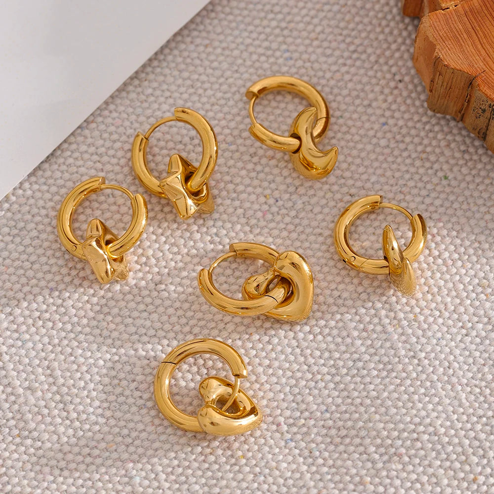 Huggie hoops with charm in gold tone, styled shot on linen – Charmhabit