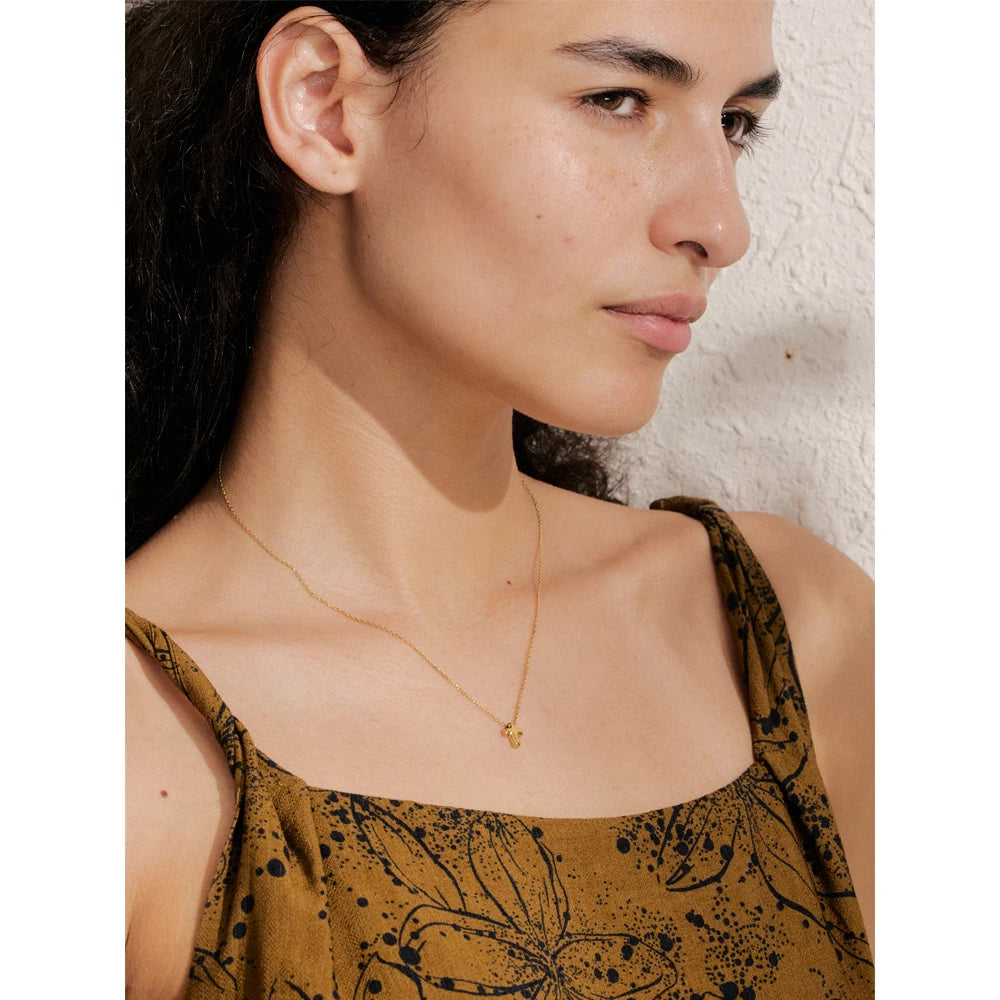 Necklace with a small cross pendant worn – Charmhabit