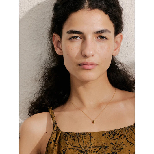 Necklace with a small cross pendant worn – Charmhabit