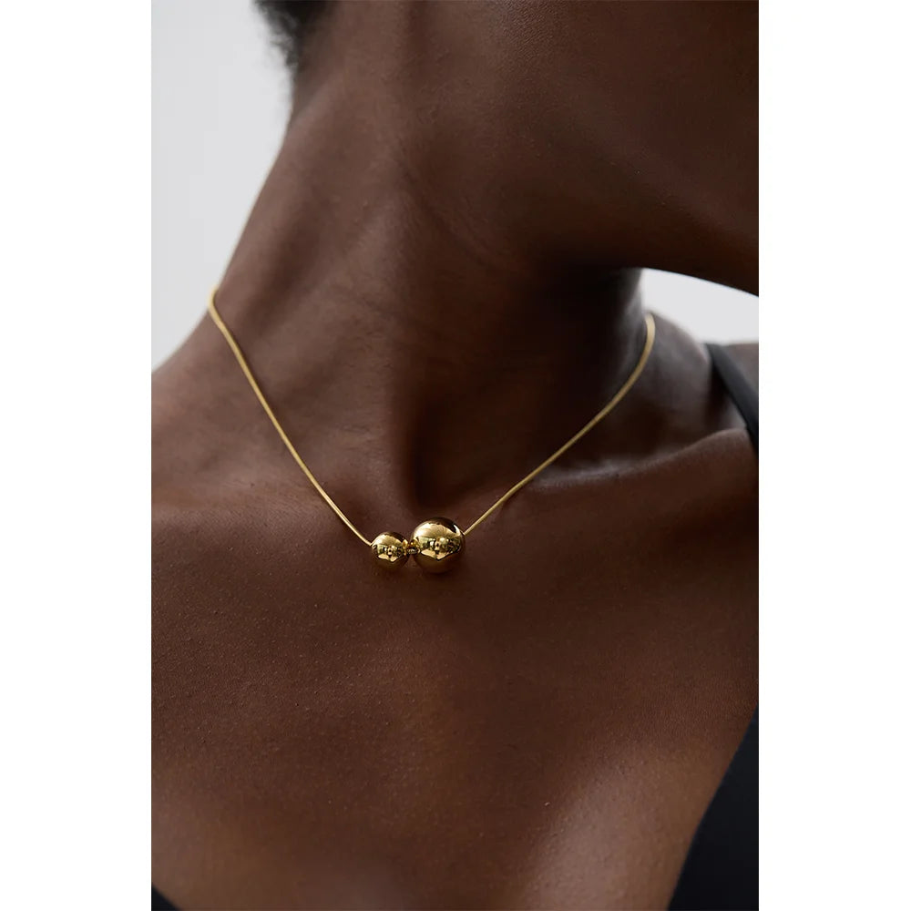 Collier à deux boules, porté, gros plan – Charmhabit