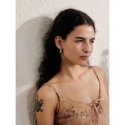Two-tone dome huggie hoops, worn – Charmhabit