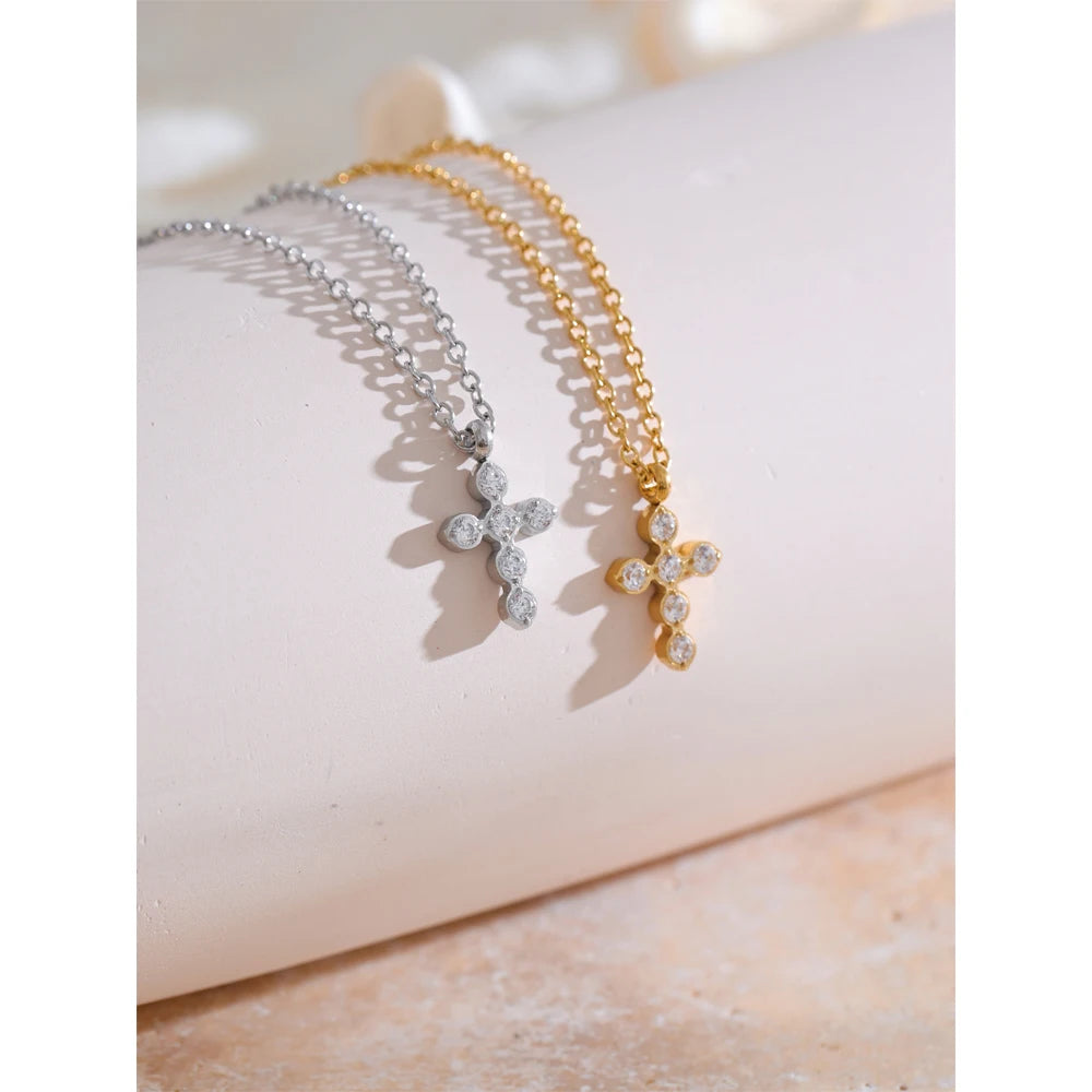 Necklace with cross and zirconia, gold and silver tone, styled shot on a light surface – Charmhabit