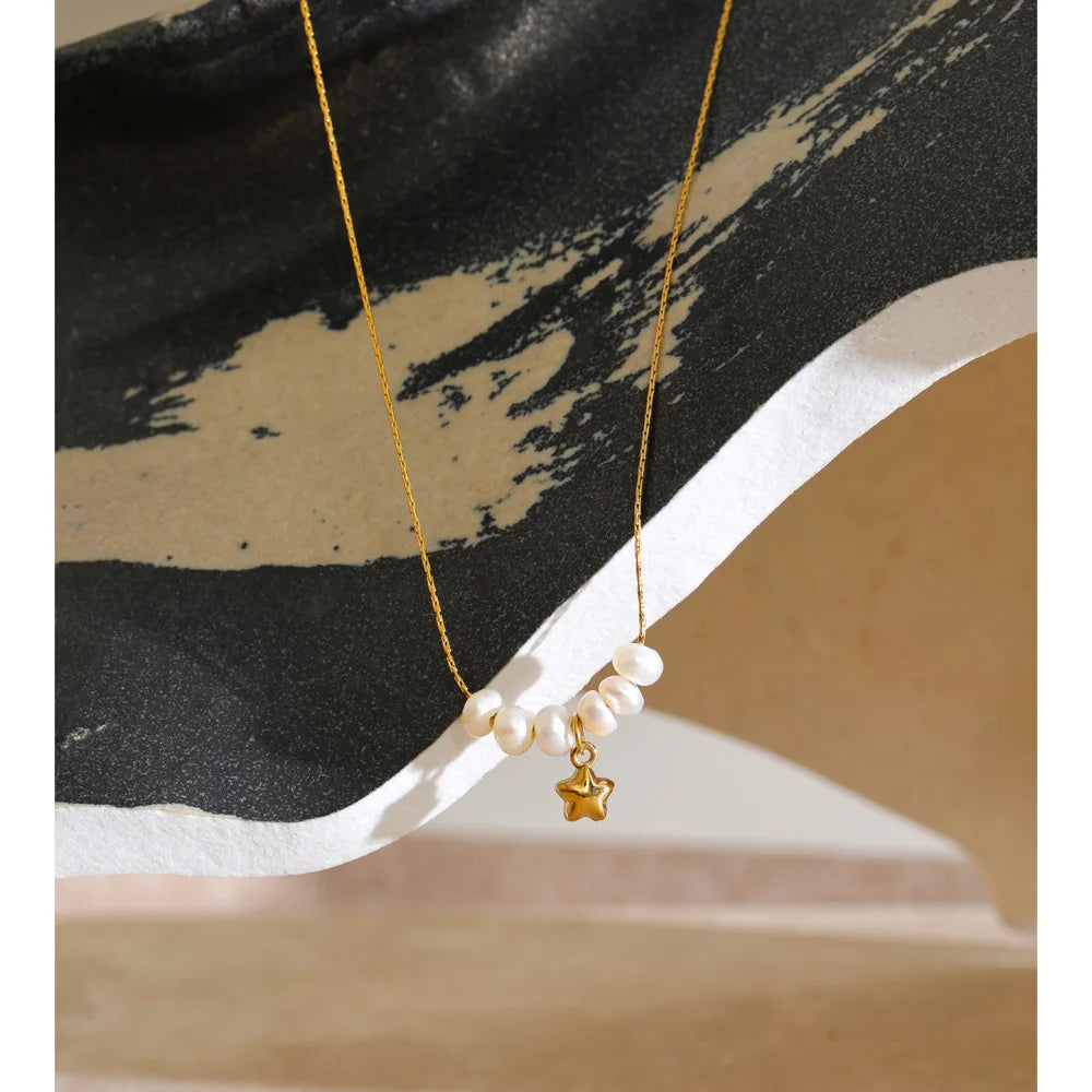 Styled shot of a pearl necklace with star pendant – Charmhabit