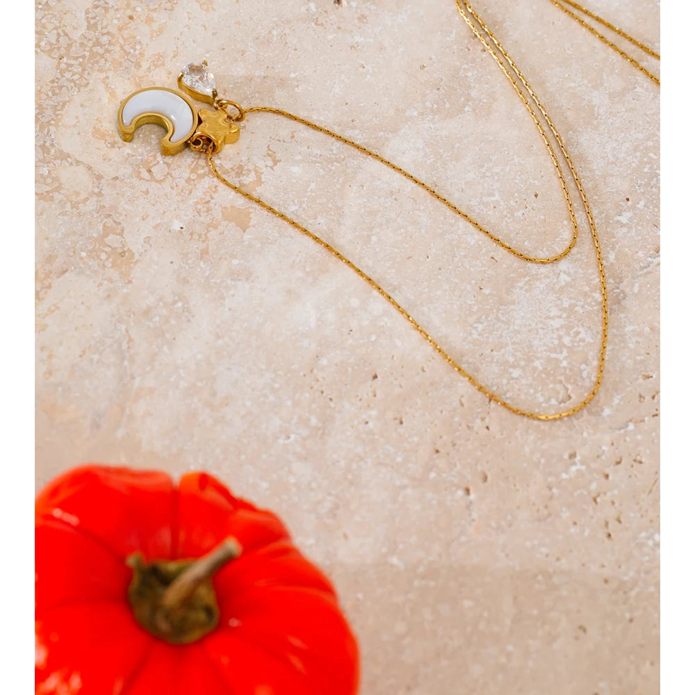 Necklace with shell, moon and star pendant, styled shot – Charmhabit