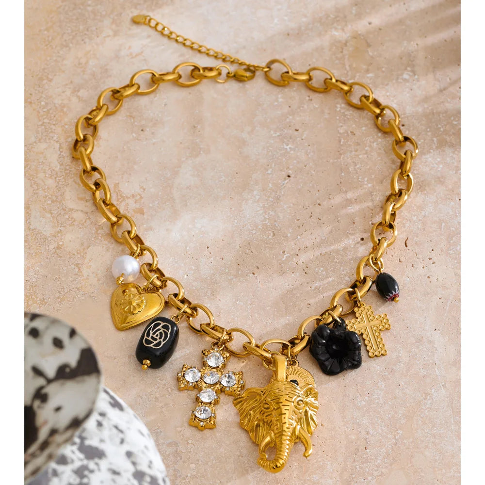 Charm necklace with heart, flower and cross, styled shot – Charmhabit