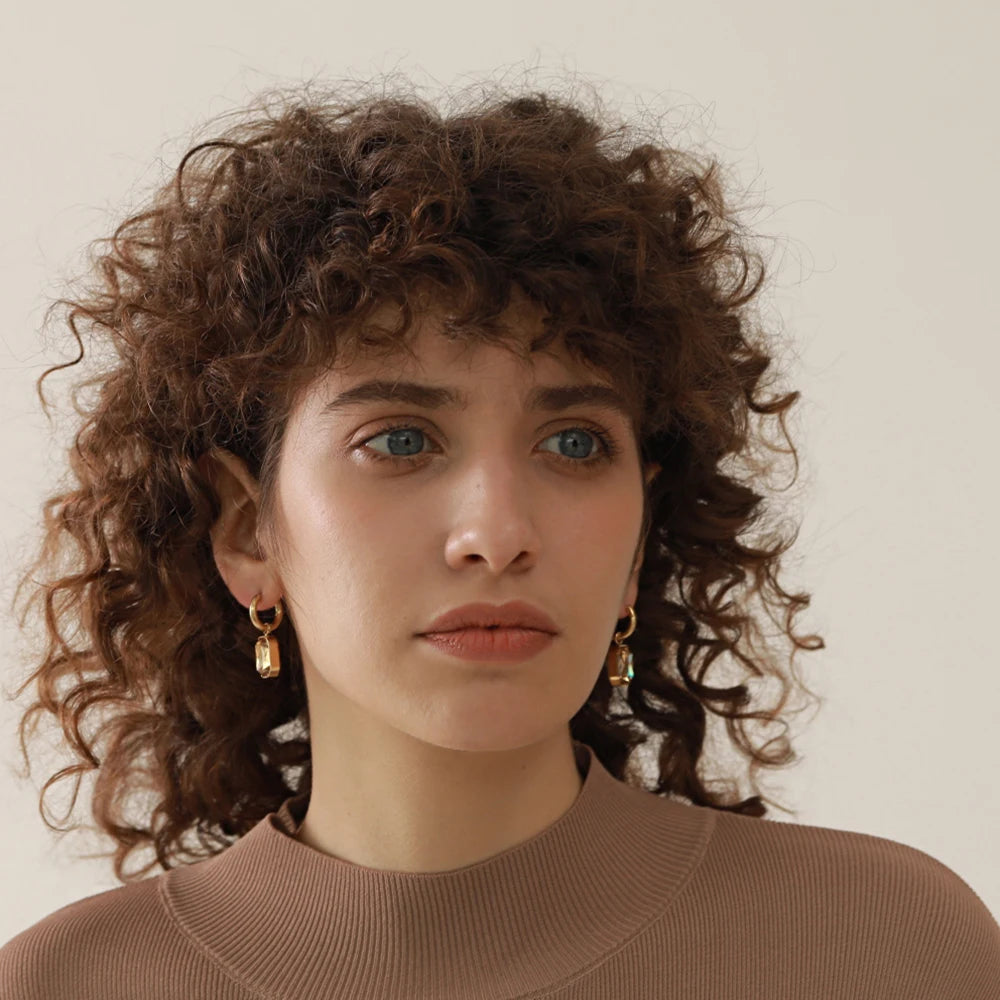 Huggie hoops with an octagonal crystal pendant, worn, portrait – Charmhabit