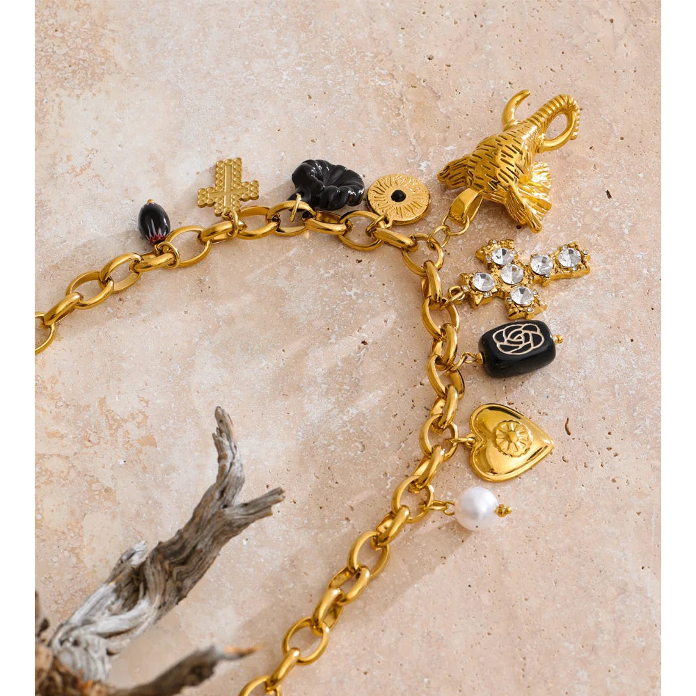 Charm necklace with heart, flower and cross, styled shot – Charmhabit
