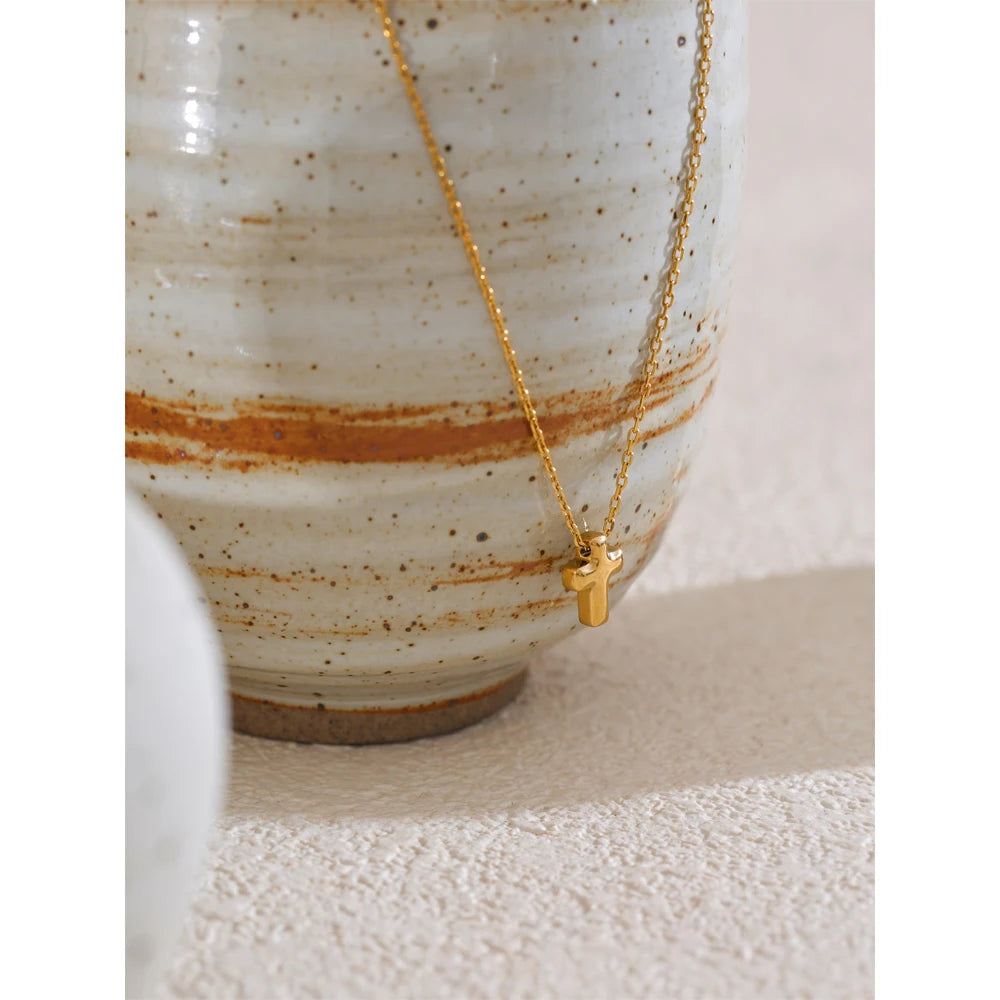 Necklace with a small cross pendant styled shot – Charmhabit