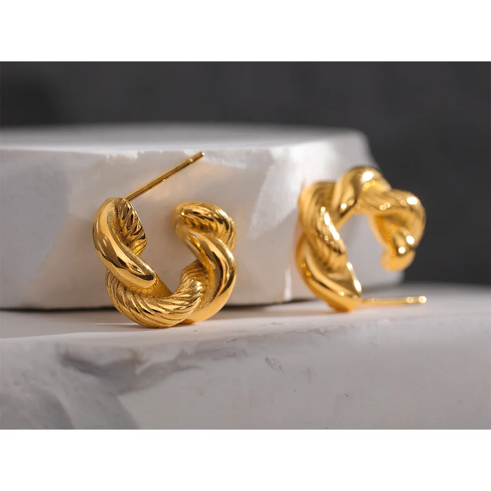 Twisted hoop earrings, gold tone, styled shot on stone – Charmhabit