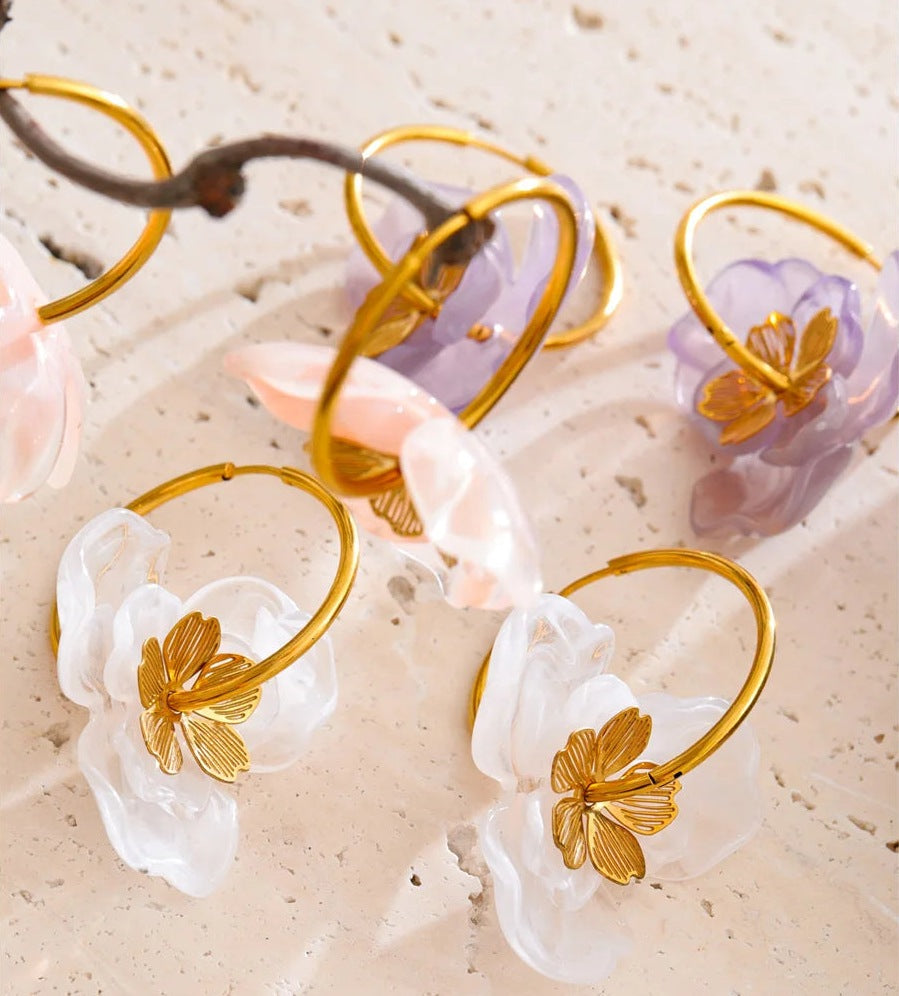 Resin flower hoop earrings on a soft surface – Charmhabit