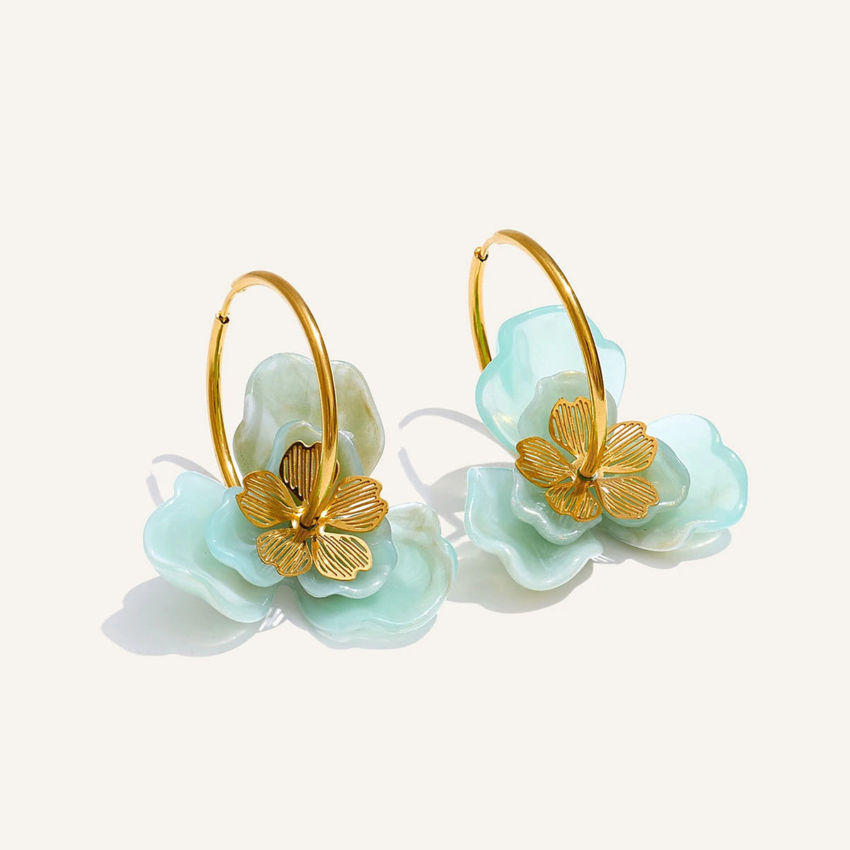 Resin flower hoop earrings with a mint flower on a light background – Charmhabit