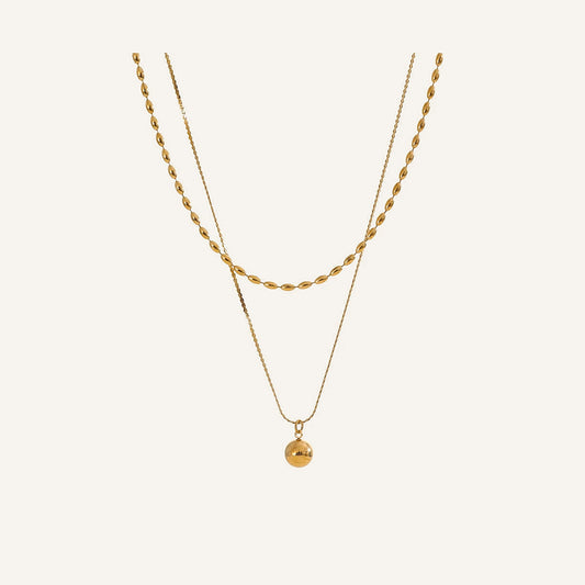 Double necklace with ball pendant, gold tone, on a light background – Charmhabit