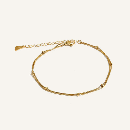 Double beaded anklet, gold tone, on a light background – Charmhabit