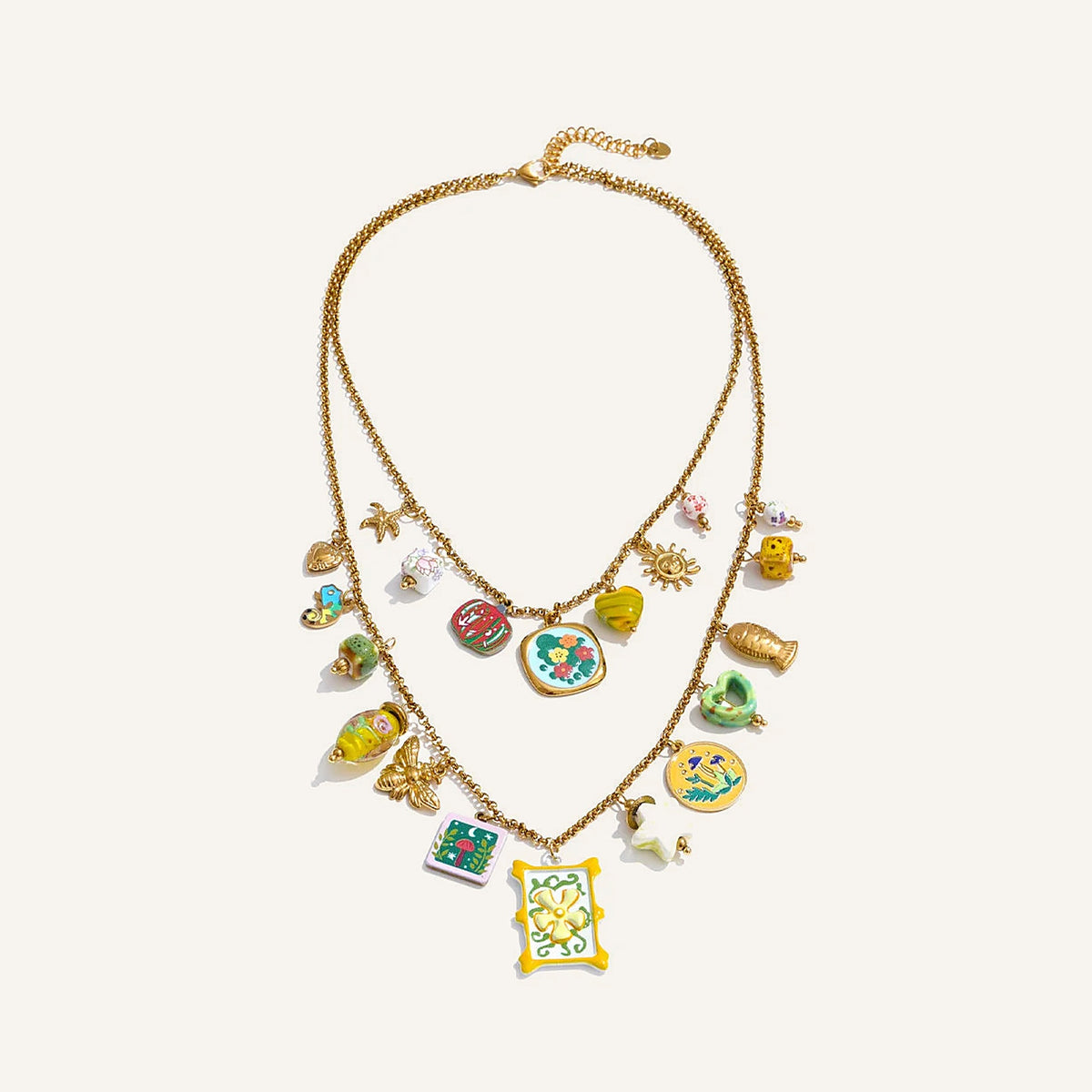 Collier superposé avec breloques colorées, doré, sur fond clair – Charmhabit