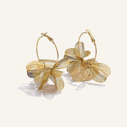 Large hoop earrings with a metal flower, gold tone, on a light background – Charmhabit