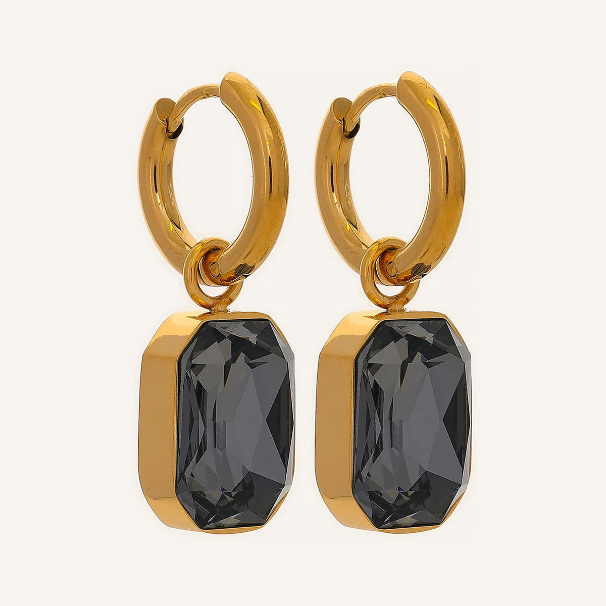 Huggie hoops with an octagonal crystal pendant in grey, on a light background – Charmhabit