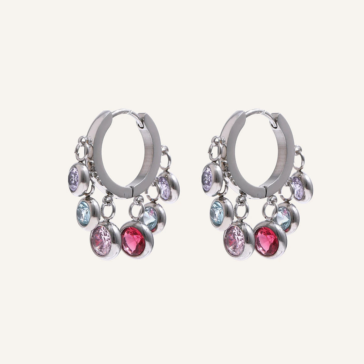 Créoles huggies avec pampilles en zircon coloré, argentées, sur fond clair – Charmhabit