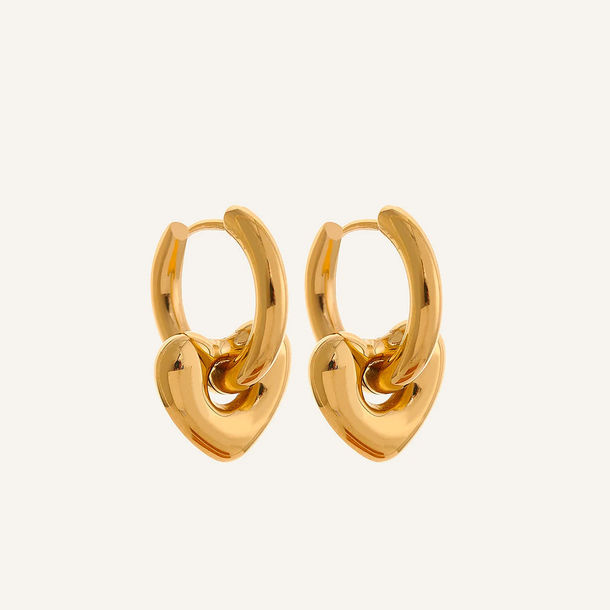 Huggie hoops with rounded heart charm, gold tone, on a light background – Charmhabit