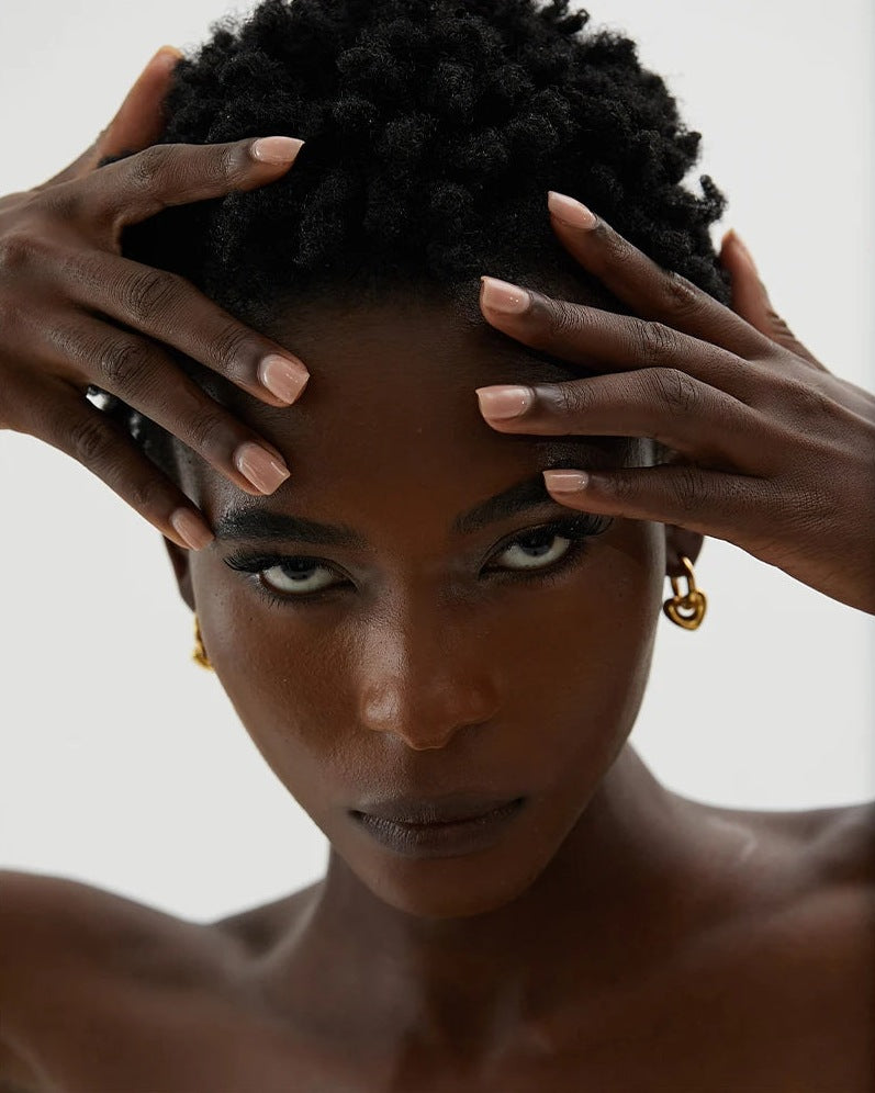 Huggie hoops with charm, worn by a woman – Charmhabit