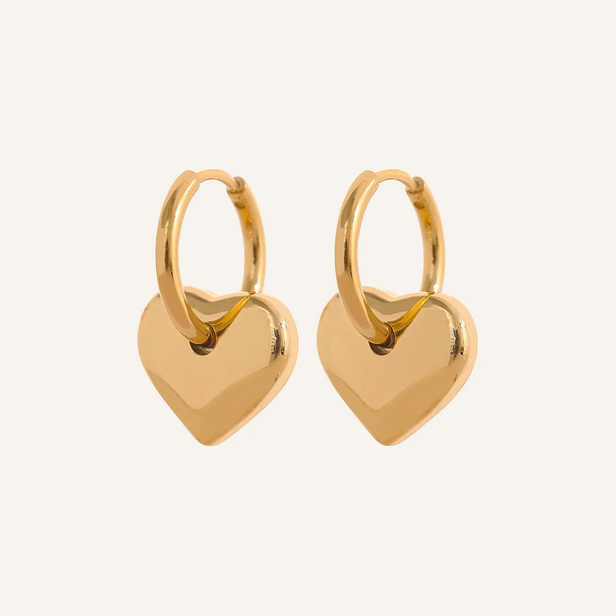 Huggie hoops with flat heart charm, gold tone, on a light background – Charmhabit