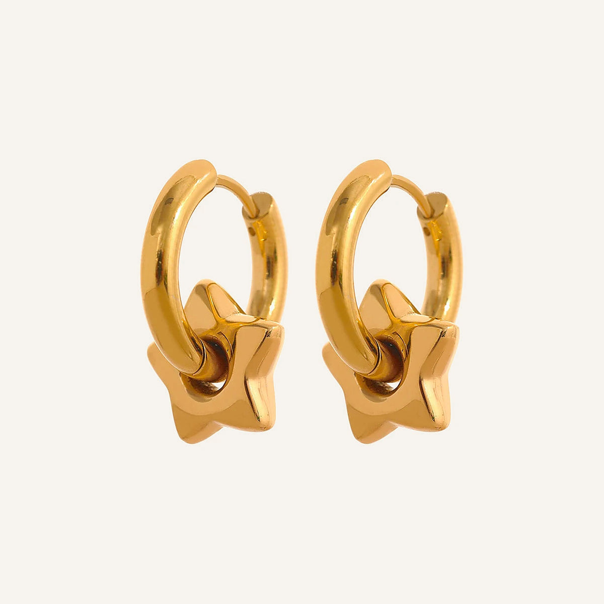 Huggie hoops with star charm, gold tone, on a light background – Charmhabit