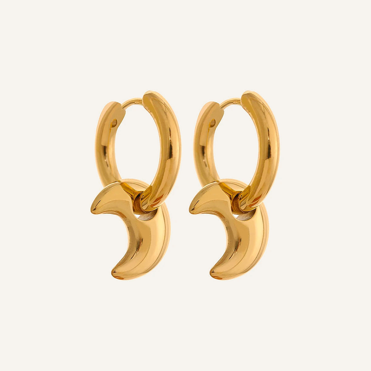 Huggie hoops with moon charm, gold tone, on a light background – Charmhabit