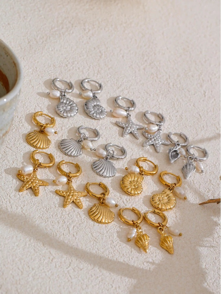 Huggie hoops with sea charm and pearl in gold and silver tone, styled shot – Charmhabit
