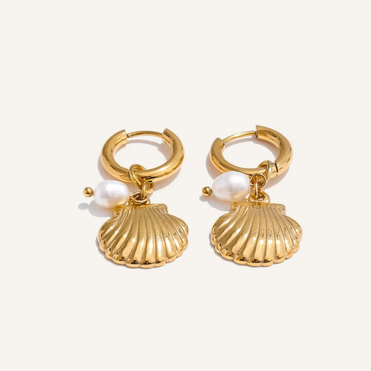 Huggie hoops with sea charm and pearl, shell, gold tone, on a light background – Charmhabit