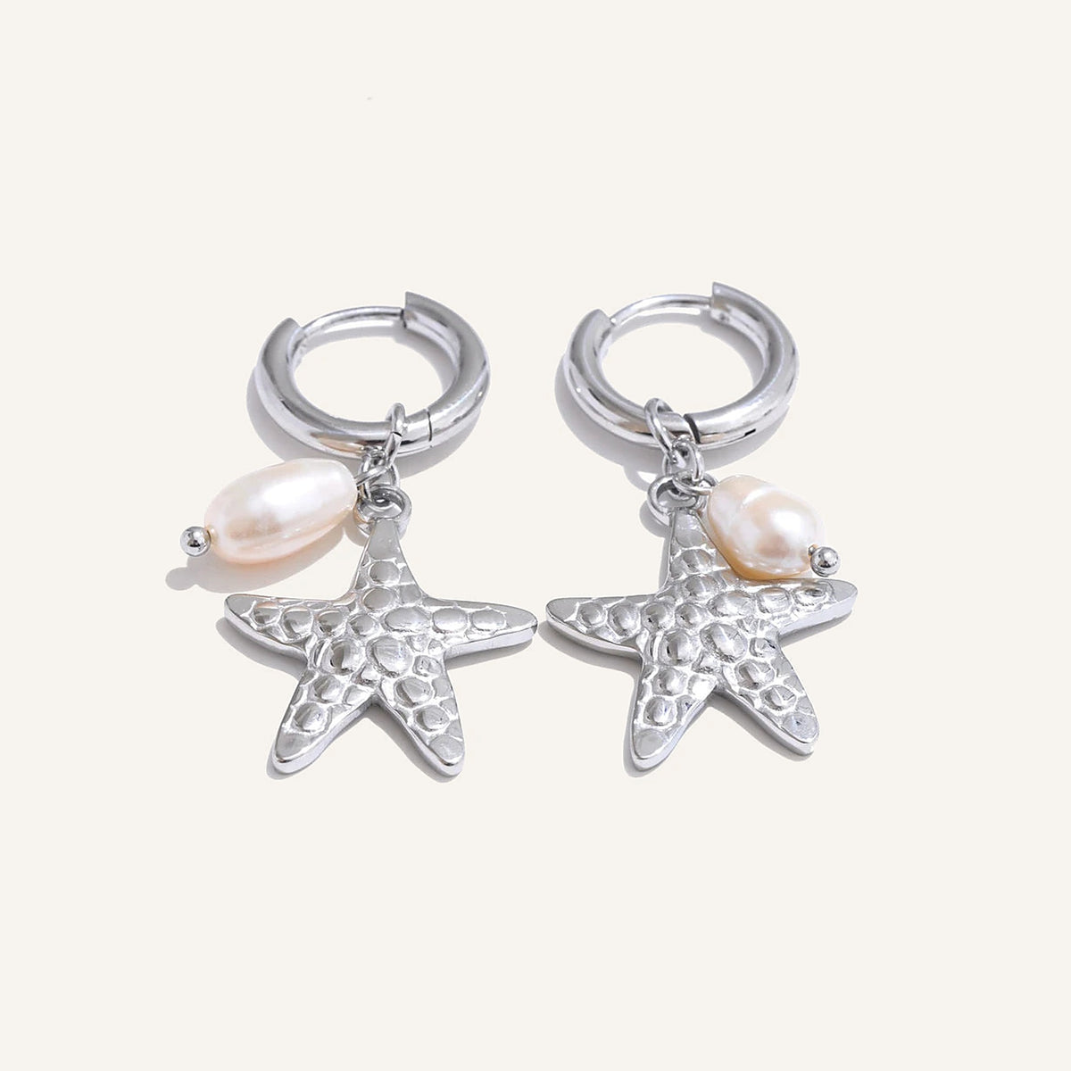 Huggie hoops with sea charm and pearl, starfish, silver tone, on a light background – Charmhabit