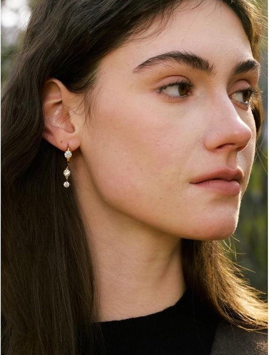 Huggie hoops with a cubic zirconia pendant, worn – Charmhabit